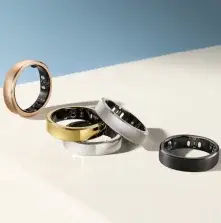 Collection of dental rings and bands in gold, silver, and black finishes displayed on white surface.
